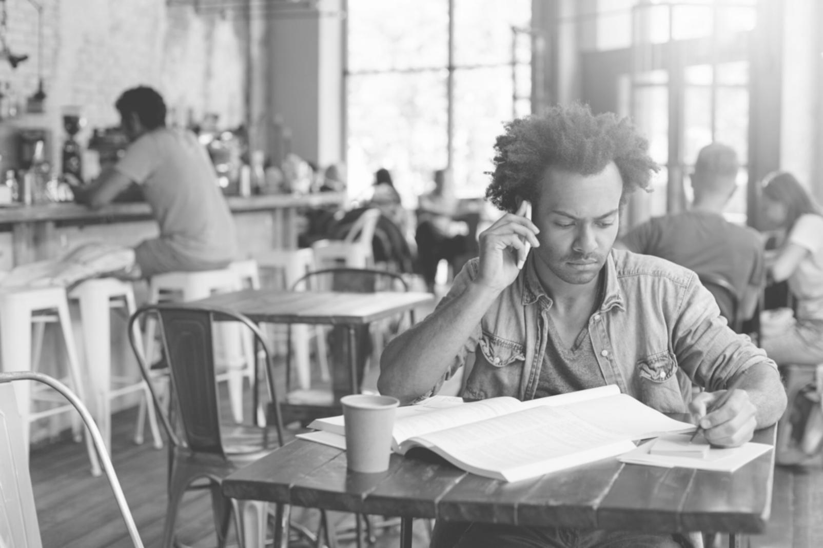 Person reviewing complex financial documents with calculator and scattered papers